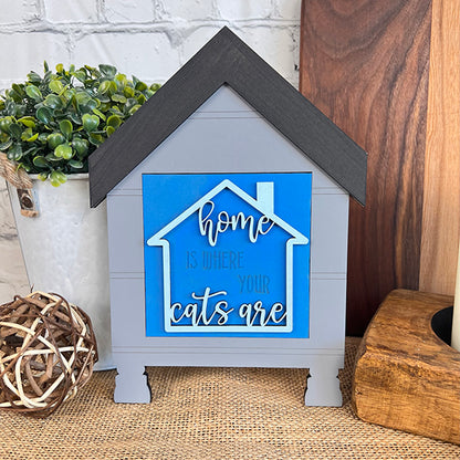 Janet's Craft Corner Cat Swappable Squares: A house-shaped sign in blue and white reads "Home is where your cats are." Perfect for DIY seasonal decor, display with a plant, candle, wooden board, or wicker ball.
