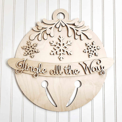 Introducing the Jingle Bell Door Hanger from Janet's Craft Corner: a wooden DIY craft kit designed as a holiday ornament adorned with snowflakes and greenery. It showcases the phrase "Jingle all the Way" in cursive, complete with a cut-out jingle bell pattern at the bottom, making it an ideal addition to enhance your home décor.