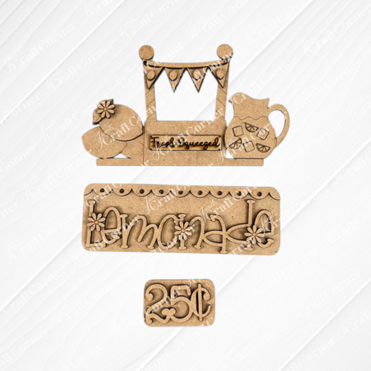 A set of wooden cutouts from Janet's Craft Corner beautifully displays a "Fresh Squeezed" lemonade stand scene on a textured backdrop, featuring elements like a chicken, an ice-filled pitcher, the word "lemonade," and a "25¢" price tag. This Lemonade Interchangeable Insert DIY home décor kit is perfect for adding charm to your space or using as an interchangeable decor piece.