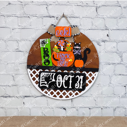 An enchanting Halloween-themed display depicts a stained door hanger with lattice bottom and signs that say "Boo," "Trick or Treat," and "Oct 31." This DIY craft kit from Janet's Craft Corner, named the Oct 31 Interchangeable Insert, features hand-painted elements including candies, a black cat with a pumpkin, and other festive decorations—ideal for creating versatile home decor.