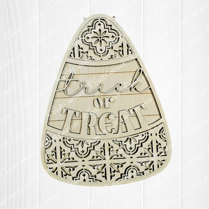 Decorative wooden cutout shaped like a candy corn with 'Trick or Treat' text on a white background