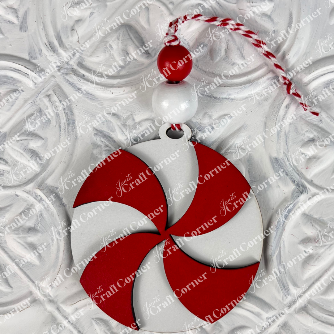 Introducing the Round Christmas Ornaments from Janet's Craft Corner! These DIY Decoration Kits feature red and white swirled ornaments adorned with two beads and a red and white twisted string, all set against a textured white backdrop. Perfect for adding festive charm to your holiday decorations.
