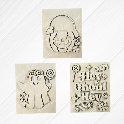 Janet's Craft Corner Halloween Farmhouse Signs: set of 3 wooden cutouts—a floral jack-o'-lantern, ghost with lollipop and flowers, and "Hey Ghoul Hey" tiered tray sign with candy—perfect for DIY seasonal home decor.
