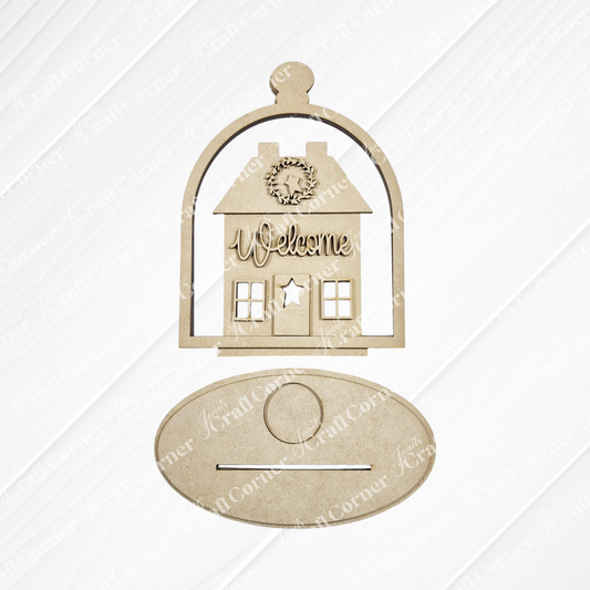 Janet's Craft Corner Salt Box Votive Holder Cloche is a DIY seasonal home decor kit featuring an unfinished wood house with a “Welcome” wreath, displayed under a cloche, plus an oval plaque for personalized crafting. Set of 1.