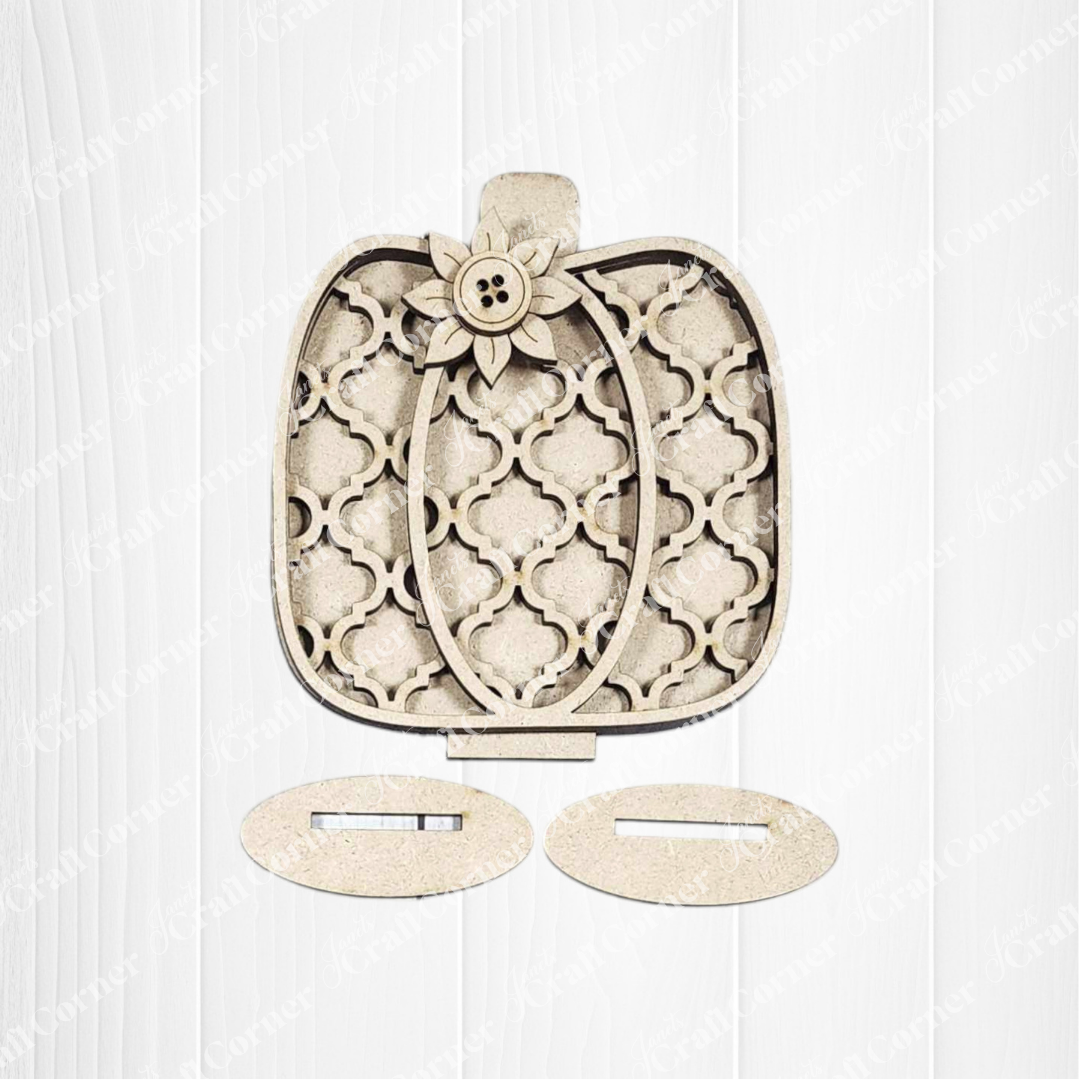 Janet's Craft Corner Fall Harvest Mini Shelf Sitters DIY kit features a wooden pumpkin with a lattice design, flower button accent, and oval stands—ideal for autumn home decor or crafting projects. Set of 1.