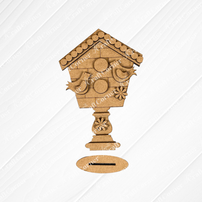 Janet's Craft Corner presents the Spring Standing Signs, a decorative DIY kit featuring a wooden birdhouse design against a white tile backdrop. The kit includes circular elements and two bird shapes, complemented by athe white wooden background, making it ideal for home décor or as part of your Spring Standing Signs collection.