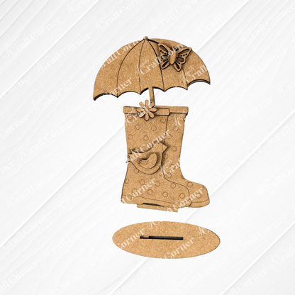 Introducing the "Spring Standing Signs" from Janet's Craft Corner—a decorative wooden cutout that showcases rain boots adorned with a delicate flower, topped with an umbrella and butterfly. Set against a white wooden background, it's an ideal choice for either a welcoming spring display or an enchanting DIY home décor project.