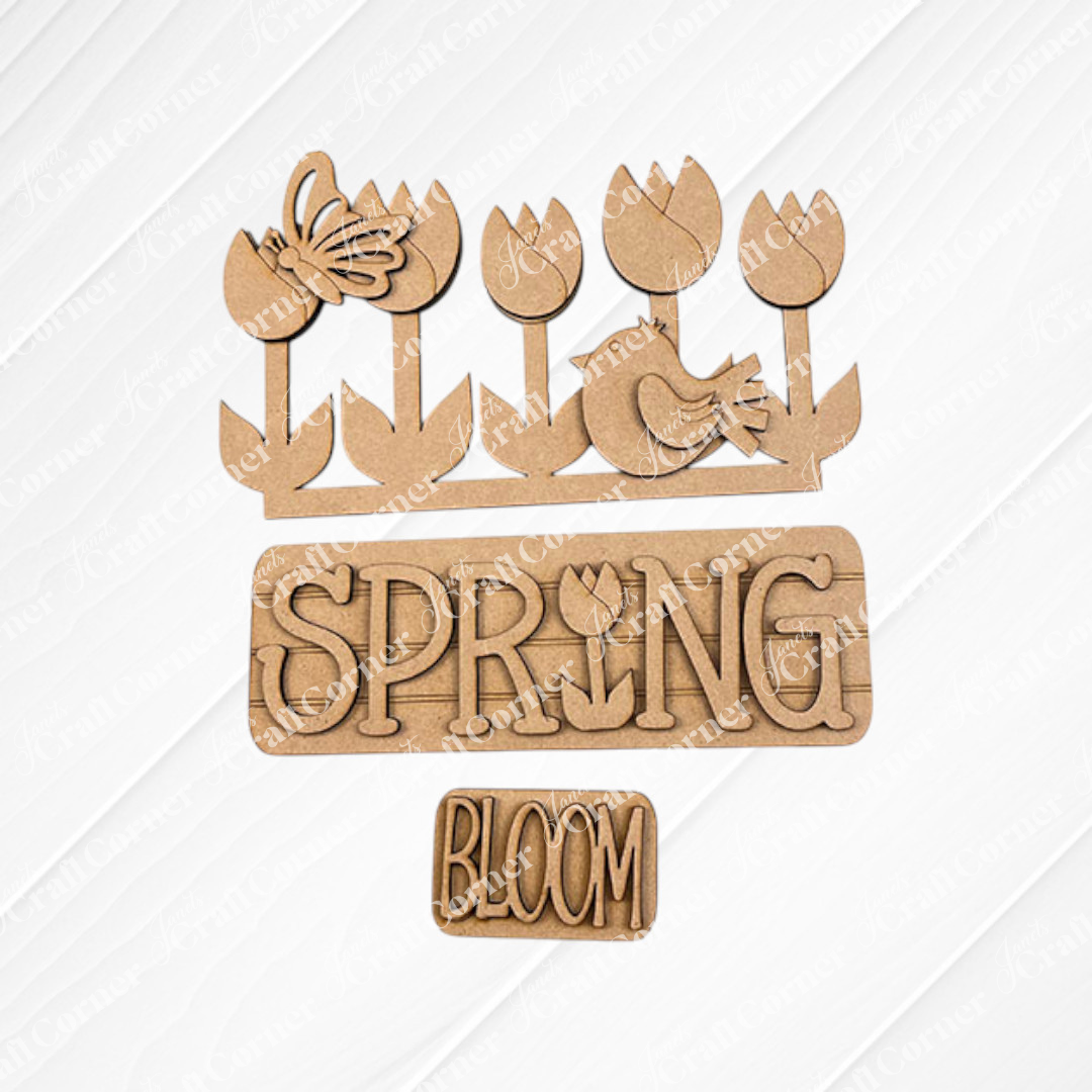 The Spring Tulips Interchangeable Insert from Janet's Craft Corner is a delightful DIY home decor kit that includes hand-painted wooden cutouts with a floral and spring theme. Featuring tulips, a butterfly, a bird, and the words "SPRING" with a tulip in place of the letter "I" and "BLOOM," this craft kit allows you to easily update your seasonal display.