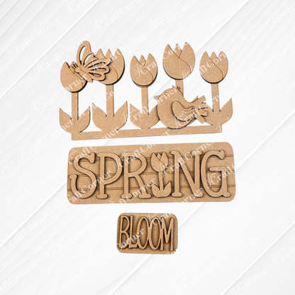 The Spring Tulips Interchangeable Insert from Janet's Craft Corner is a delightful DIY home decor kit that includes hand-painted wooden cutouts with a floral and spring theme. Featuring tulips, a butterfly, a bird, and the words "SPRING" with a tulip in place of the letter "I" and "BLOOM," this craft kit allows you to easily update your seasonal display.