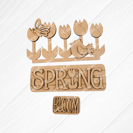 The Spring Tulips Interchangeable Insert from Janet's Craft Corner is a delightful DIY home decor kit that includes hand-painted wooden cutouts with a floral and spring theme. Featuring tulips, a butterfly, a bird, and the words "SPRING" with a tulip in place of the letter "I" and "BLOOM," this craft kit allows you to easily update your seasonal display.