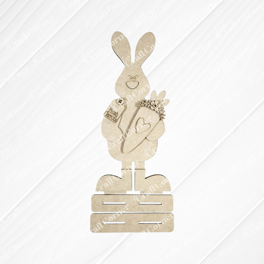 Bring spring charm to your home with Janet’s Craft Corner Standing Carrot Bunny Shelf Sitter DIY kit—this set includes a wooden bunny holding a heart-carved carrot and “thank you” sign, perfect for seasonal decorating.