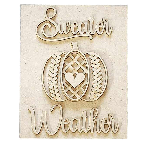 The "Sweater Weather Interchangeable Sign" from Janet's Craft Corner is a delightful DIY home decor craft kit featuring the phrase "Sweater Weather" in an elegant script font. Accented with a carved pumpkin heart and leaf patterns, this sign adds a cozy seasonal warmth to your space against its light wooden background.