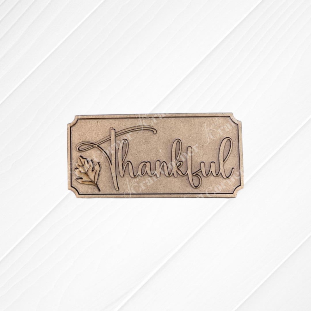 The Thankful Mini Shelf Sitter by Janet's Craft Corner is a DIY seasonal home decor kit featuring "Thankful" engraved in cursive with a leaf design—perfect for your Thankful Decor Set or creating unique personalized decorations.