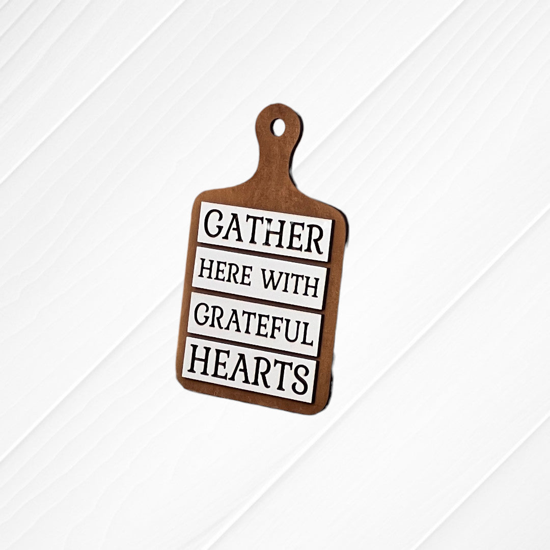 The Thankful Mini Shelf Sitters from Janet’s Craft Corner is a DIY seasonal home decor craft kit featuring "GATHER HERE WITH GRATEFUL HEARTS" in black and white—perfect for your thankful decor set.