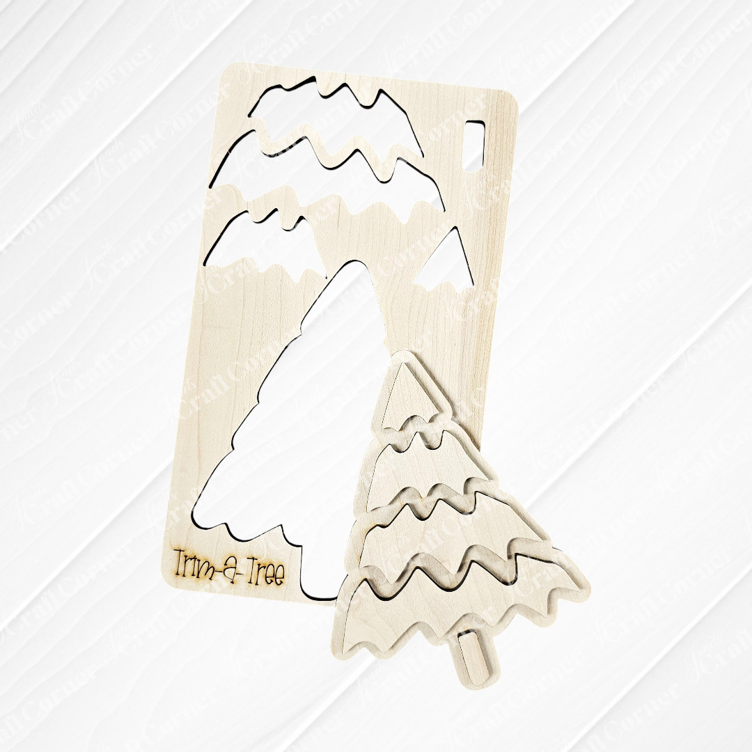 Experience the finest in holiday decor with Janet's Craft Corner's "Trim a Tree Kids Pop-Out Kit." This DIY craft kit features a wooden Christmas tree puzzle with a distinctive cut-out piece in front. The stylized tree showcases wavy branch patterns and an engraved "Trim-a-Tree" on its base. Set against a white brick wall, it serves as a charming accent for any festive setting.