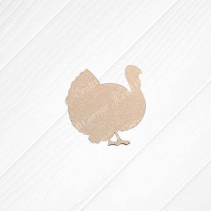 A Thankful Mini Shelf Sitter from Janet's Craft Corner—a DIY seasonal home decor craft kit featuring a plain brown turkey cutout—is displayed on a white, grooved wooden surface.