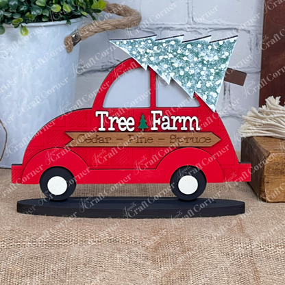 The Tree Farm Volkswagen Shelf Sitter DIY home decor craft kit from Janet's Craft Corner offers a charming hand-painted ornament, featuring a red truck carrying a frosted green Christmas tree on its roof. The truck is adorned with the words "Tree Farm" and "Cedar Pine Spruce," making it an ideal addition to your home décor.