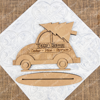 The "Tree Farm Volkswagen Shelf Sitter", a DIY home décor craft kit from Janet's Craft Corner, features a hand-painted wooden cutout of a vintage car carrying a Christmas tree. It is labeled "Tree Farm" with the words "Cedar - Pine - Spruce," making it an ideal piece for home decoration. Set against a textured background, this charming item adds a rustic touch to any space.