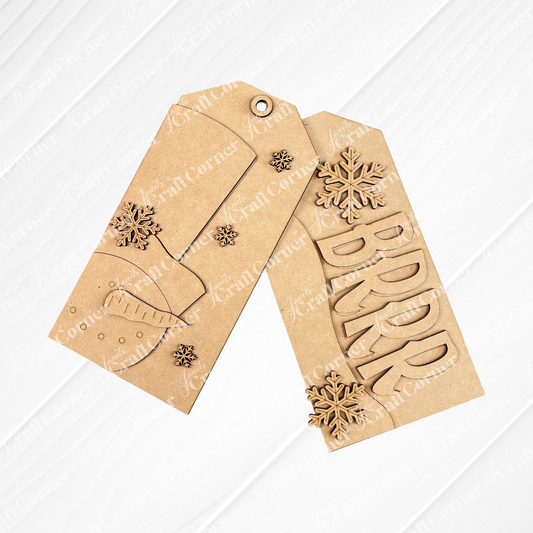 Two Winter Door Tags by Janet's Craft Corner: one says "BRRR" with snowflakes, the other shows a carrot and snowflakes—ideal for seasonal DIY home decor. Both wooden tags are shown on a white wood background.