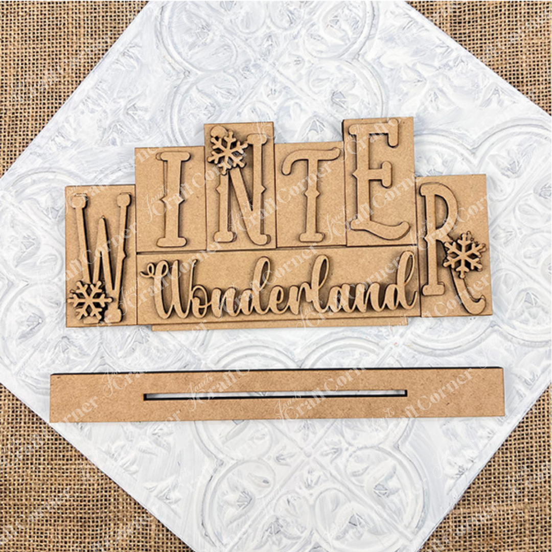 Wooden cutout letters spelling 'Winter Wonderland' on a textured white background.