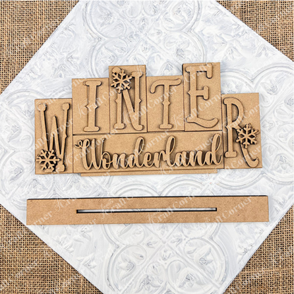 Wooden cutout letters spelling 'Winter Wonderland' on a textured white background.