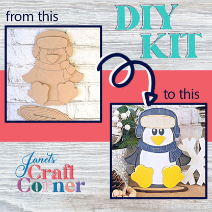 DIY project displaying a cardboard penguin on the left and a painted Janet's Craft Corner Woodland Friends Penguin Shelf Sitter with winter gear and a snowflake on the right. Text reads "from this" to "DIY kit" to "this." Background features the Janet's Craft Corner logo.