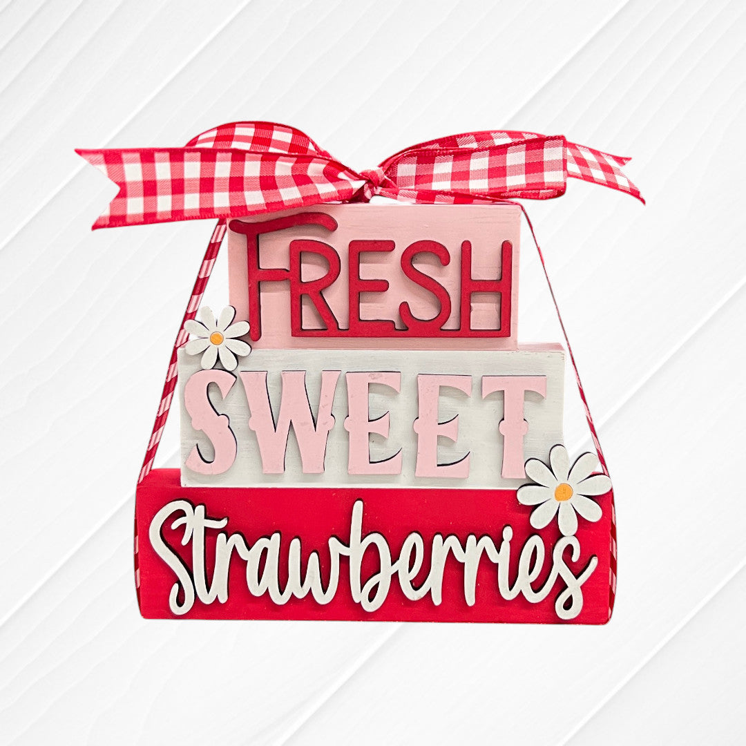 The Word Stacks - Painted by Janet's Craft Corner features decorative blocks tied with a red and white gingham ribbon, reading “Fresh Sweet Strawberries,” with white daisy accents on a red, pink, and white background.