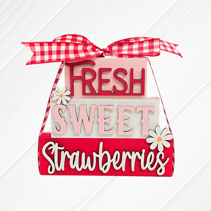 The Word Stacks - Painted by Janet's Craft Corner features decorative blocks tied with a red and white gingham ribbon, reading “Fresh Sweet Strawberries,” with white daisy accents on a red, pink, and white background.