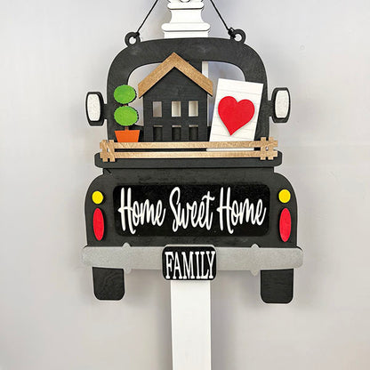 Introducing the "Antique Truck Base with Interchangeable Insert" from Janet's Craft Corner. This DIY home decor kit features a decorative sign crafted in the shape of an antique truck, complete with charming details like a house, heart, and plant in the back. Adorned with "Home Sweet Home" in elegant white cursive and "Family" in bold letters on a crisp white strip below, it offers customizable appeal with interchangeable inserts for seasonal flair.