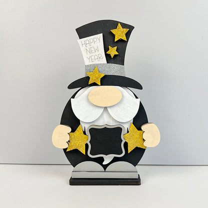 Discover the delightful Happy New Year Gnome Shelf Sitter from Janet's Craft Corner, a charming enhancement to your home décor. This gnome features a tall black hat decorated with gold stars and holds a festive "Happy New Year" sign. With its white beard and star in hand, it adds whimsical joy against a simple gray backdrop.