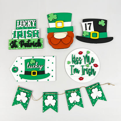 Explore Janet's Craft Corner's Lucky St Patricks Tiered Tray Kit for your home décor, featuring green and black hats, clover designs, a leprechaun beard, and festive signs with phrases such as "Lucky," "Irish," and "Kiss Me I'm Irish." Enhance your space with a garland of green flags and shamrocks.