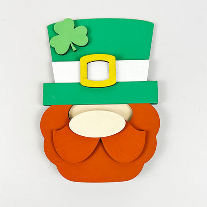 Enhance your home décor collection with Janet's Craft Corner's Lucky St Patricks Tiered Tray Kit, featuring a whimsical cutout of a leprechaun's hat and beard. The green hat is adorned with a white band, yellow buckle, and shamrock, perfectly complemented by the bushy orange beard and mustache below. Perfect for festive decorating!