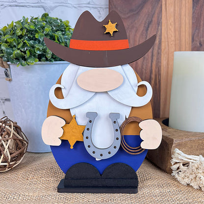 The Cowboy Gnome by Janet's Craft Corner is a decorative wooden figure designed as an egg-shaped cowboy gnome, complete with a hat, mustache, and star badge. It holds a horseshoe and rope and is displayed in authentic farmhouse style on a woven surface next to a plant, woven ball, and candle.