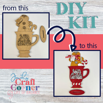 Elevate your decor with the Gingerbread Hot Cocoa Mug Shelf Sitter DIY kit, perfect for creating a wooden decoration themed around "Baby It's Cold Outside." Transform the unpainted pieces into a festive red mug masterpiece. Proudly crafted by Janet's Craft Corner, it's ideal as a shelf display.