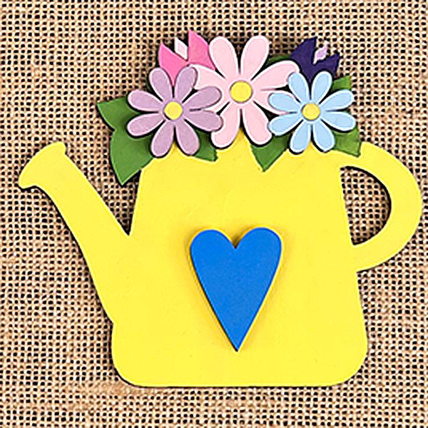 Set against a woven burlap background, the Flower Market Mini Shelf Sitters from Janet's Craft Corner feature a charming yellow watering can cutout, adorned with colorful hand-painted flowers on top and a blue heart on its front. This piece beautifully complements any Flower Market Tiered Tray Kit, adding a crafted touch to your decor.